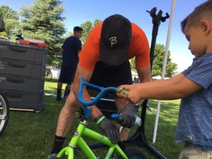 Man helps child fix bike